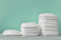 Three stacks of diapers on a turquoise background with copy space Royalty Free Stock Photo