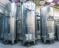 Three stainless steel wine tanks in a row in winery