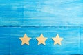 Three stars on a blue background. The concept of rating and evaluation. The rating of the hotel, restaurant, mobile application. Q Royalty Free Stock Photo