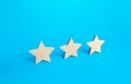Three stars on a blue background. Rating evaluation concept. Service quality. Buyer feedback. High satisfaction. Popularity rating