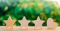 Three stars and heart on a green bokeh background. four star rating, the choice of the editorial office and the buyer. concept of