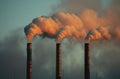 Three steam pipe chimneys emitting air into the sky, pollution and industrial impact concept Royalty Free Stock Photo