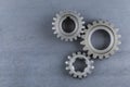 Three Steel Gears on a steel background.