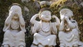 Stone figures of buddha acting like three wise monkeys Mizaru, Kikazaru, Iwazaru
