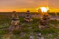 Three stone pillars with an amazing sunset in the back of the national park Waterschei in Genk