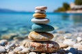 Three stones stacked by the sea, interplay of light and shadow against clear sky