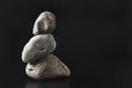 Three stones stand on top of each other keeping their balance.