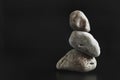 Three stones stand on top of each other keeping their balance.