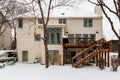 Three story home with walkout basement and a deck in snowy winter time