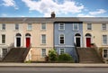 Three-story house stands beside road