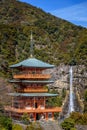 Three story pagoda of Seiganto-ji Tendai Buddhist temple in Wakayama Prefecture, Japan with Nachi Falls Royalty Free Stock Photo