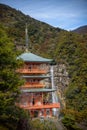 Three story pagoda of Seiganto-ji Tendai Buddhist temple in Wakayama Prefecture, Japan with Nachi Falls Royalty Free Stock Photo