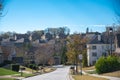 Three story, row of two-story houses along residential street leading down a steep hill in new development suburban neighborhood Royalty Free Stock Photo