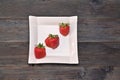 three strawberries in a beautiful white plate Royalty Free Stock Photo