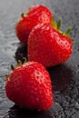Three strawberries on black Royalty Free Stock Photo