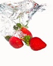 Three strawberries falling Royalty Free Stock Photo