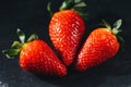 Three strawberries on gray stone. Three strawberries on a gray stone background Royalty Free Stock Photo