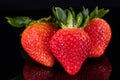 Three strawberries isolated on black Royalty Free Stock Photo