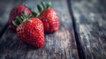 Three strawberries on a wooden table