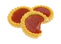 Three strawberry filled tarts with one bitten