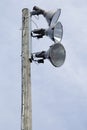 Three strong spotlights on a wooden post