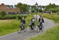 Three students ride bicycles in Zaanse Schans