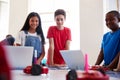 Three Students In After School Computer Coding Class Learning To Program Robot Vehicle Royalty Free Stock Photo