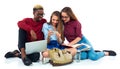 Three students sitting with books, laptop and bags isolated on w Royalty Free Stock Photo