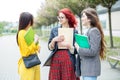 Three students are talking about their studies on the campus. Education concept, friendship and group of people Royalty Free Stock Photo