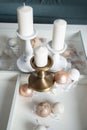 Three Stylish white large candles on the table, and New Year`s balls, photos in gentle pastel colors. Christmas mood Royalty Free Stock Photo