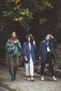 Three stylish young women in fashion clothes.