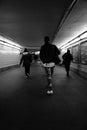 Three subjects walking underground in the subway