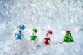 Three sugar candy bears in the snow on bokeh background with copy space for season greeting Merry Christmas or Happy New Year Royalty Free Stock Photo