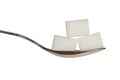 Three sugar cobes on a teaspoon Royalty Free Stock Photo