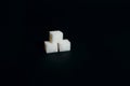 Three sugar cubes on a black background Royalty Free Stock Photo