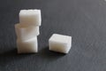 Three sugar cubes are stacked on top of each other or in a pyramid on a white gray and black background with space for inserting t Royalty Free Stock Photo