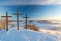 Three summit crosses on a mountain peak in a beautiful winter landscape in the Swabian Alps at sunset Royalty Free Stock Photo