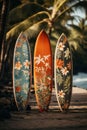 Three surf boards with vivid and eye-catching designs standing gracefully in the sand of a tropical beach