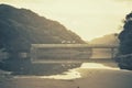 Three Surfers on a Bridge