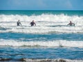 Surfers on Piha Beach, Auckland, New Zealand