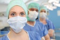 Three surgeons at work operating in surgical theatre Royalty Free Stock Photo