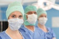 three surgeons at work operating in surgical theatre Royalty Free Stock Photo