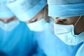 Three surgeons at work operating in surgical theatre Royalty Free Stock Photo