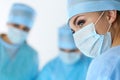 Three surgeons at work operating in surgical theatre saving pati Royalty Free Stock Photo