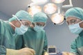 Three Surgeons At Work In Operating Theatre Royalty Free Stock Photo