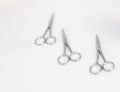Three surgical scissors placed on a white surface. Royalty Free Stock Photo