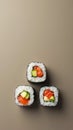 Three Sushi Rolls Placed at the Points of an Equilateral Triangle on a Muted Taupe Background Royalty Free Stock Photo