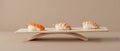 Three Sushi Rolls Placed at the Points of an Equilateral Triangle on a Muted Taupe Background Royalty Free Stock Photo