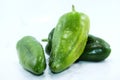 Three sweet green peppers white background
