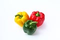 three sweet peppers red, yellow and green on a white background Royalty Free Stock Photo